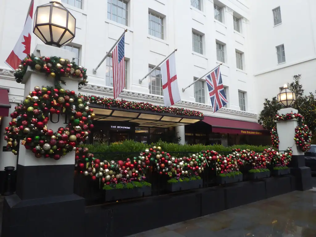 Entrance to The Beaumont Mayfair with Christmas decorations and flags